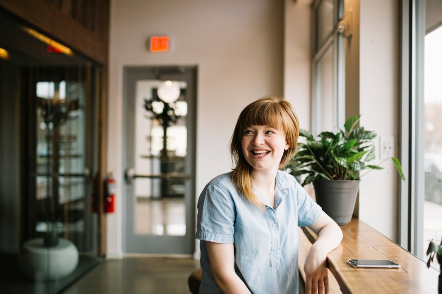 Smiling woman at a cafe table