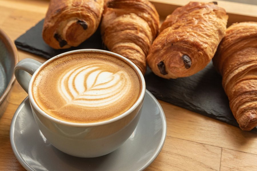 Latte and croissants on a cafe table