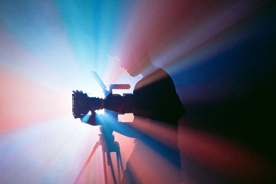 Camera operator in studio light